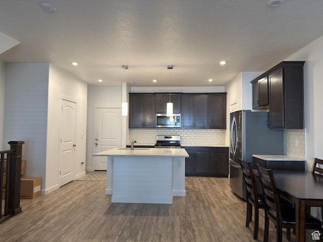 5264 S Tucker Ct W Unit 329, West Valley City, UT 84118 - kitchen featuring dark wood finished floors, a sink, a center island with sink, and appliances with stainless steel finishes