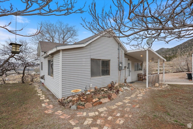 exterior space with roof with shingles