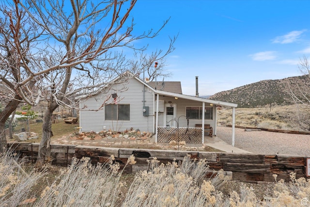 bungalow-style home with a porch and a mountain view