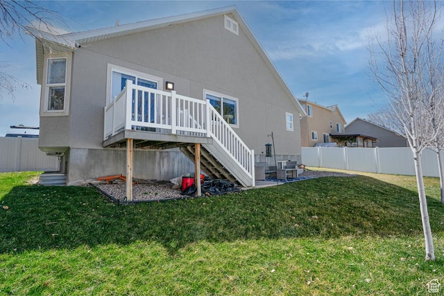 6718 W Halter Creek Way S, West Valley City, UT 84128 - back of house with stairway, stucco siding, fence, and a lawn
