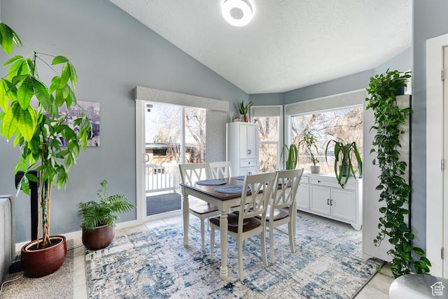 6718 W Halter Creek Way S, West Valley City, UT 84128 - dining room featuring light tile patterned floors, vaulted ceiling, and a textured ceiling