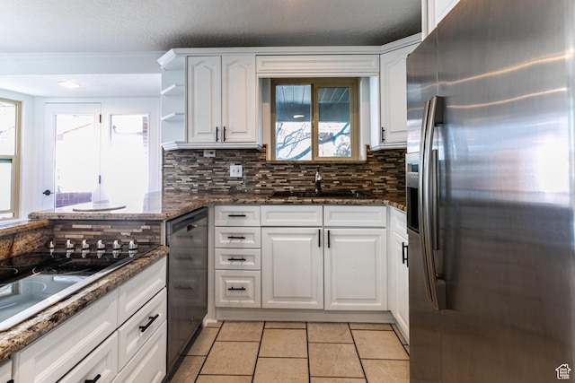 945 Church St, Layton, UT 84041 - kitchen with white cabinets, a sink, black appliances, and decorative backsplash