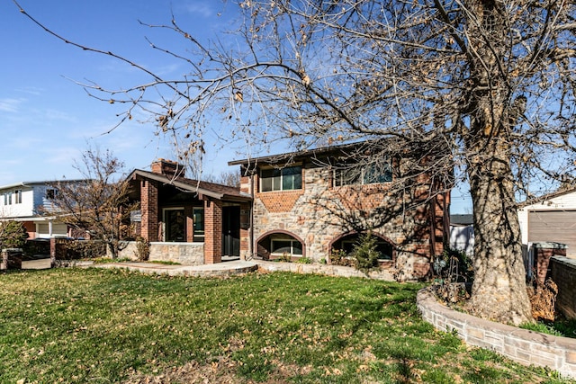 945 Church St, Layton, UT 84041 - view of front facade featuring a front yard, stone siding, a chimney, brick siding, and a garage