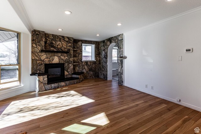 945 Church St, Layton, UT 84041 - unfurnished living room with ornamental molding, a stone fireplace, and wood finished floors