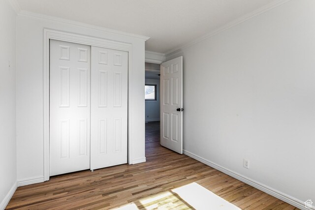 945 Church St, Layton, UT 84041 - unfurnished bedroom featuring baseboards, wood finished floors, a closet, and crown molding