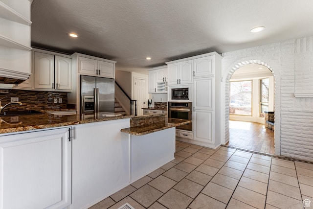 945 Church St, Layton, UT 84041 - kitchen with a sink, open shelves, appliances with stainless steel finishes, a peninsula, and dark stone counters