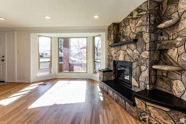 945 Church St, Layton, UT 84041 - living area with baseboards, ornamental molding, wood finished floors, recessed lighting, and a stone fireplace