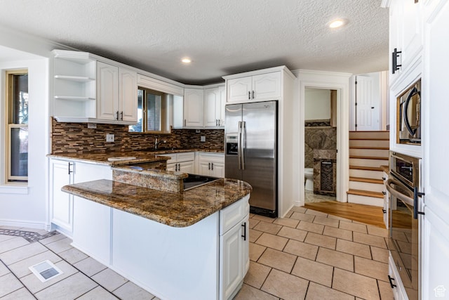 945 Church St, Layton, UT 84041 - kitchen featuring white cabinets, dark stone countertops, appliances with stainless steel finishes, and open shelves