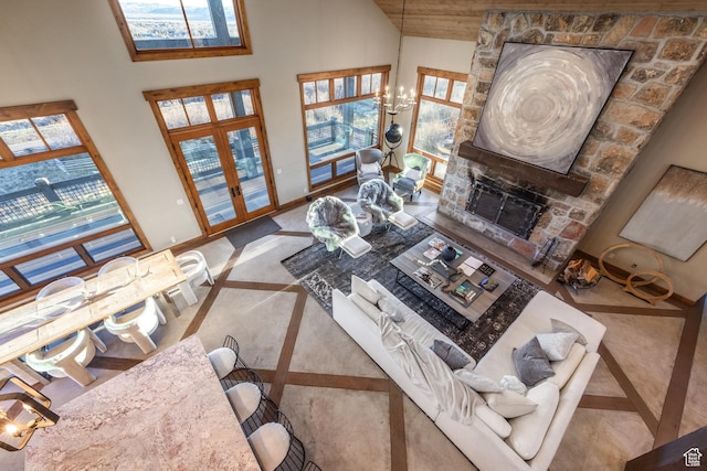 5956 N Triple Crown Trl, Oakley, UT 84055 - living area with an inviting chandelier, high vaulted ceiling, baseboards, and a fireplace