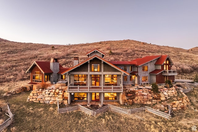 5956 N Triple Crown Trl, Oakley, UT 84055 - rear view of property featuring a balcony, a chimney, and a mountain view
