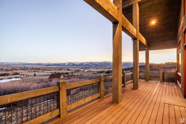 5956 N Triple Crown Trl, Oakley, UT 84055 - deck at dusk featuring a water and mountain view