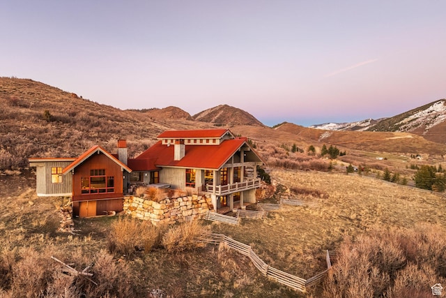 5956 N Triple Crown Trl, Oakley, UT 84055 - rear view of house with a chimney and a mountain view