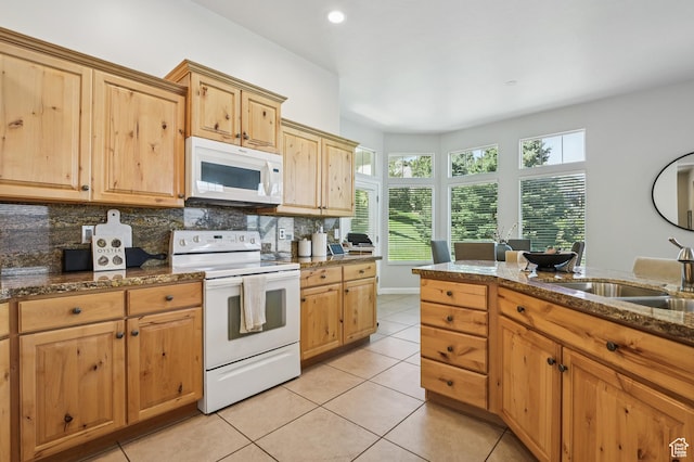 14146 S Spyglass Hill Dr, Draper, UT 84020 - kitchen featuring white appliances, tasteful backsplash, light tile patterned flooring, dark stone counters, and recessed lighting