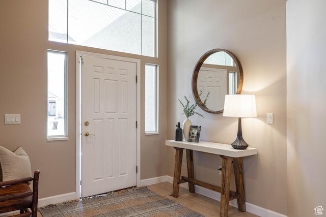 14146 S Spyglass Hill Dr, Draper, UT 84020 - foyer featuring baseboards, light tile patterned flooring, and a towering ceiling