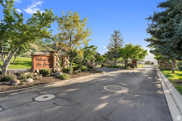 14146 S Spyglass Hill Dr, Draper, UT 84020 - view of asphalt road featuring curbs and a gated entry