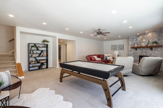 14146 S Spyglass Hill Dr, Draper, UT 84020 - recreation room with light carpet, recessed lighting, a stone fireplace, a ceiling fan, and baseboards