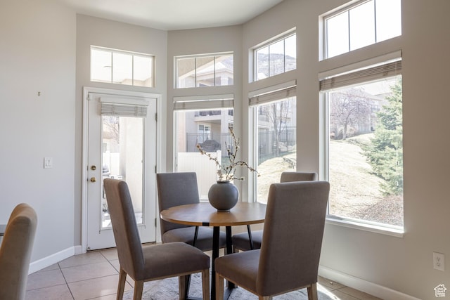 14146 S Spyglass Hill Dr, Draper, UT 84020 - dining room featuring baseboards, a high ceiling, and light tile patterned floors