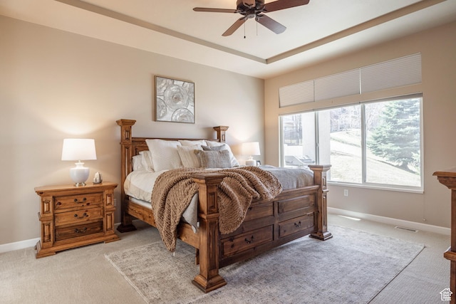 14146 S Spyglass Hill Dr, Draper, UT 84020 - bedroom with light carpet, baseboards, a tray ceiling, and a ceiling fan