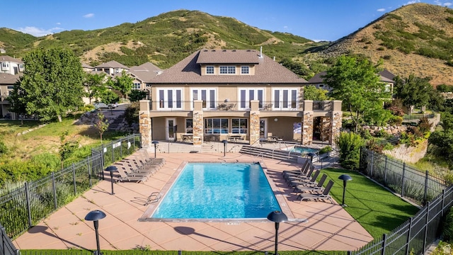 14146 S Spyglass Hill Dr, Draper, UT 84020 - rear view of property with stucco siding, a balcony, stone siding, french doors, and a patio