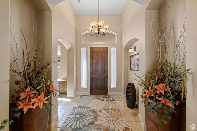 1041 E Silver Shadows Dr, Washington, UT 84780 - entrance foyer with a towering ceiling, arched walkways, baseboards, and a notable chandelier