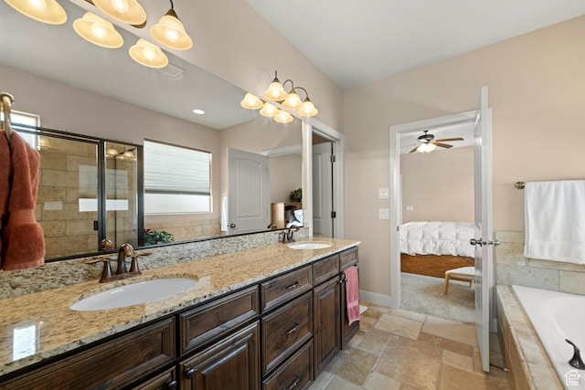 1041 E Silver Shadows Dr, Washington, UT 84780 - full bathroom with double vanity, a sink, stone tile flooring, and a garden tub