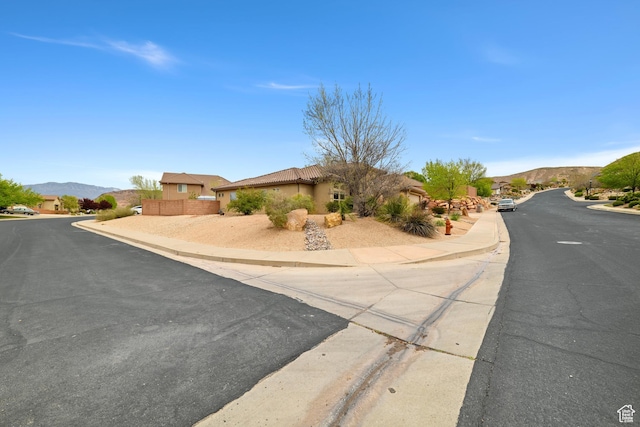 1041 E Silver Shadows Dr, Washington, UT 84780 - view of street with sidewalks, a mountain view, and curbs