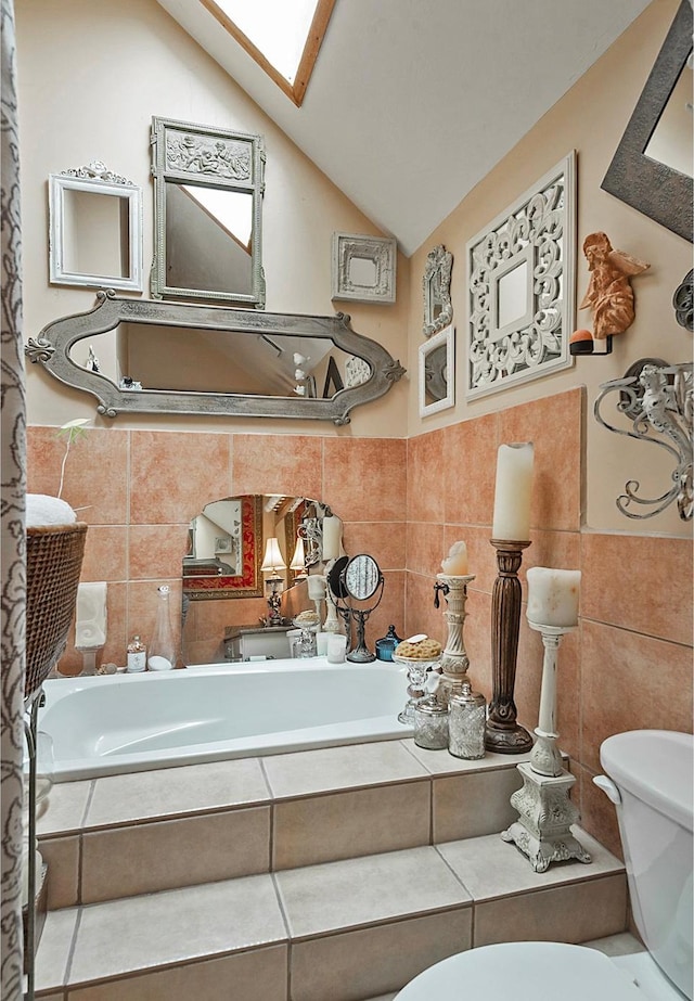 178 N Valley View Dr, North Salt Lake, UT 84054 - bathroom featuring toilet, lofted ceiling with skylight, and tile walls