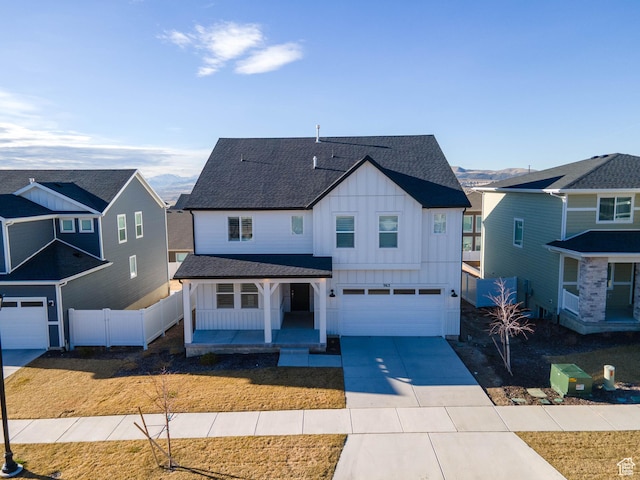 963 W Ruddy Clover Ln Unit 282, Saratoga Springs, UT 84045 - view of front facade featuring fence, a porch, board and batten siding, and roof with shingles