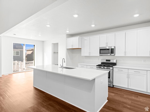 963 W Ruddy Clover Ln Unit 282, Saratoga Springs, UT 84045 - kitchen with a sink, appliances with stainless steel finishes, dark wood finished floors, a center island with sink, and white cabinets