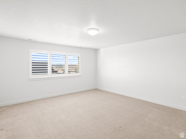 963 W Ruddy Clover Ln Unit 282, Saratoga Springs, UT 84045 - spare room with visible vents, light carpet, baseboards, and a textured ceiling