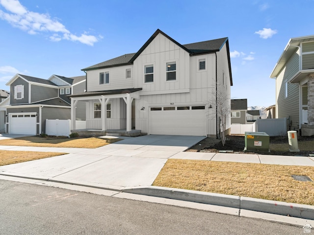 963 W Ruddy Clover Ln Unit 282, Saratoga Springs, UT 84045 - modern inspired farmhouse with covered porch, concrete driveway, fence, board and batten siding, and a garage