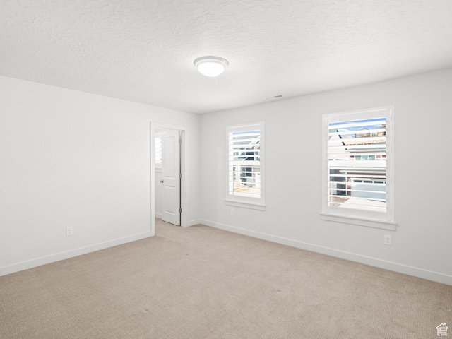 963 W Ruddy Clover Ln Unit 282, Saratoga Springs, UT 84045 - unfurnished room with light carpet, baseboards, and a textured ceiling