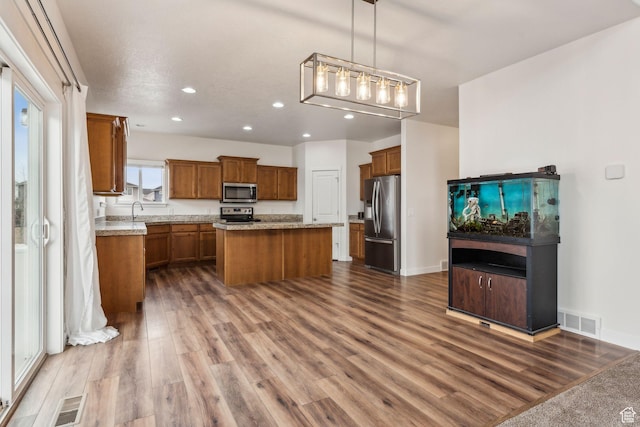 4 E Sterling Loop, Vineyard, UT 84059 - kitchen featuring visible vents, appliances with stainless steel finishes, dark wood-type flooring, a sink, and brown cabinetry