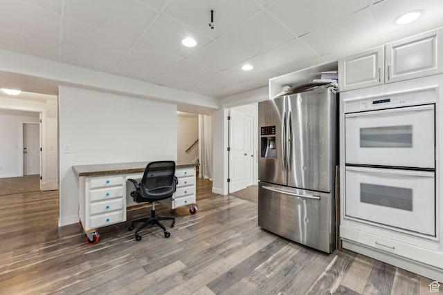 4 E Sterling Loop, Vineyard, UT 84059 - kitchen featuring wood finished floors, stainless steel fridge, white double oven, white cabinets, and a paneled ceiling