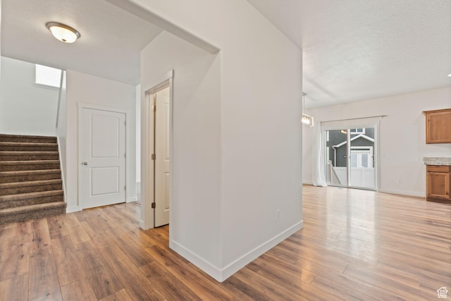 4 E Sterling Loop, Vineyard, UT 84059 - hall featuring hardwood / wood-style flooring, stairway, a textured ceiling, and baseboards