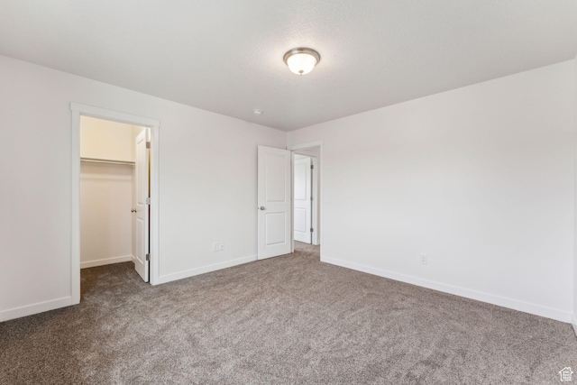 4 E Sterling Loop, Vineyard, UT 84059 - unfurnished bedroom featuring a closet, carpet floors, a spacious closet, a textured ceiling, and baseboards