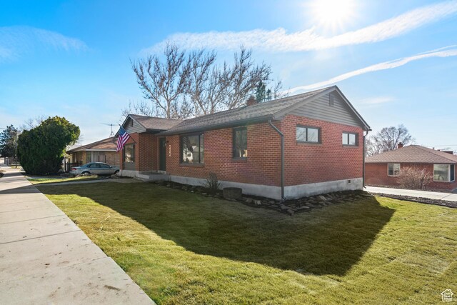223 N Harrison Blvd, Ogden, UT 84404 - view of home's exterior with a lawn and brick siding