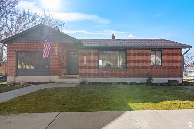 223 N Harrison Blvd, Ogden, UT 84404 - ranch-style home featuring brick siding, a chimney, a front lawn, and a shingled roof
