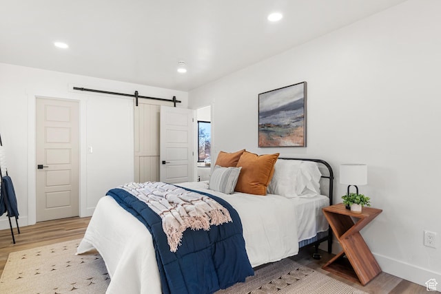 223 N Harrison Blvd, Ogden, UT 84404 - bedroom with light wood-style floors, baseboards, a barn door, and recessed lighting