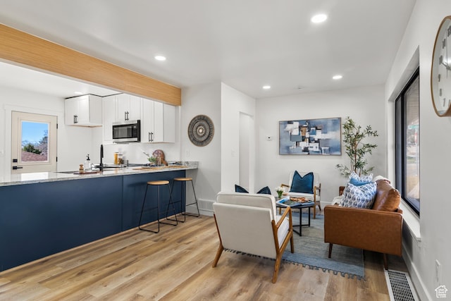 223 N Harrison Blvd, Ogden, UT 84404 - living room with baseboards, recessed lighting, and light wood-style floors