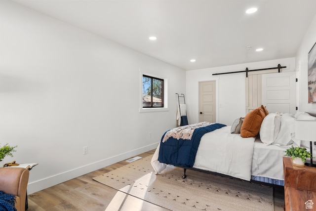 223 N Harrison Blvd, Ogden, UT 84404 - bedroom featuring baseboards, a barn door, recessed lighting, and light wood finished floors