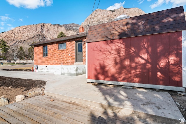 223 N Harrison Blvd, Ogden, UT 84404 - rear view of property with brick siding, a mountain view, and an attached garage