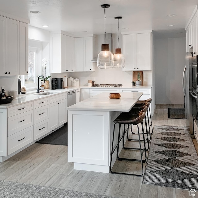 5188 S Saddleback Dr, Holladay, UT 84117 - kitchen with white cabinets, a kitchen island, appliances with stainless steel finishes, and a sink