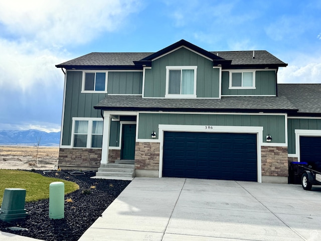 386 S Amber Field Dr Unit 508, Grantsville, UT 84029 - view of front of home with board and batten siding, driveway, stone siding, and a garage