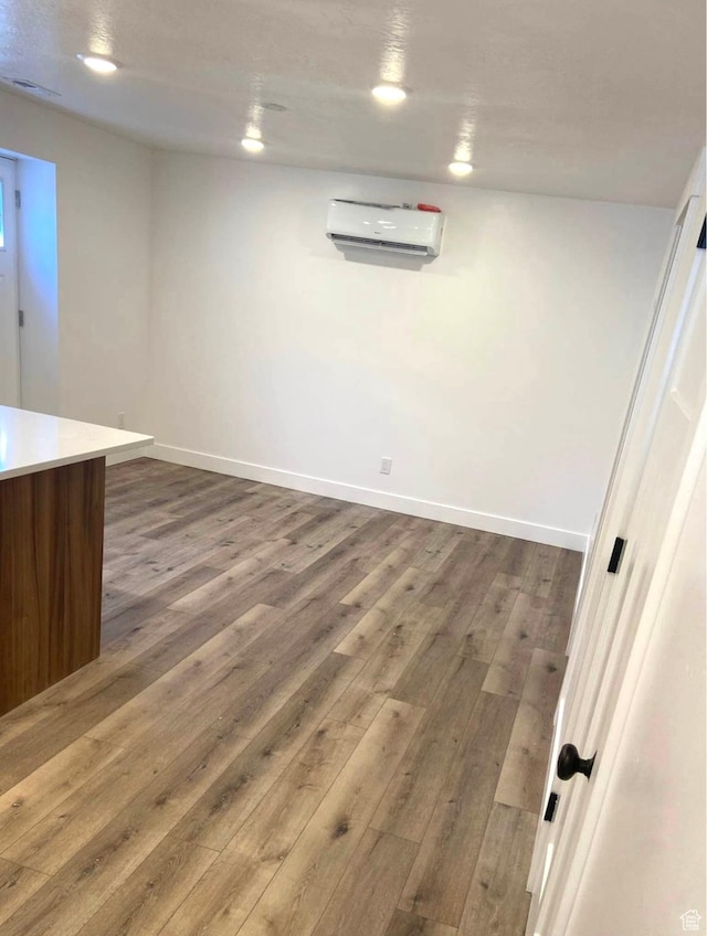 386 S Amber Field Dr Unit 508, Grantsville, UT 84029 - basement featuring a wall mounted air conditioner, baseboards, wood finished floors, and recessed lighting