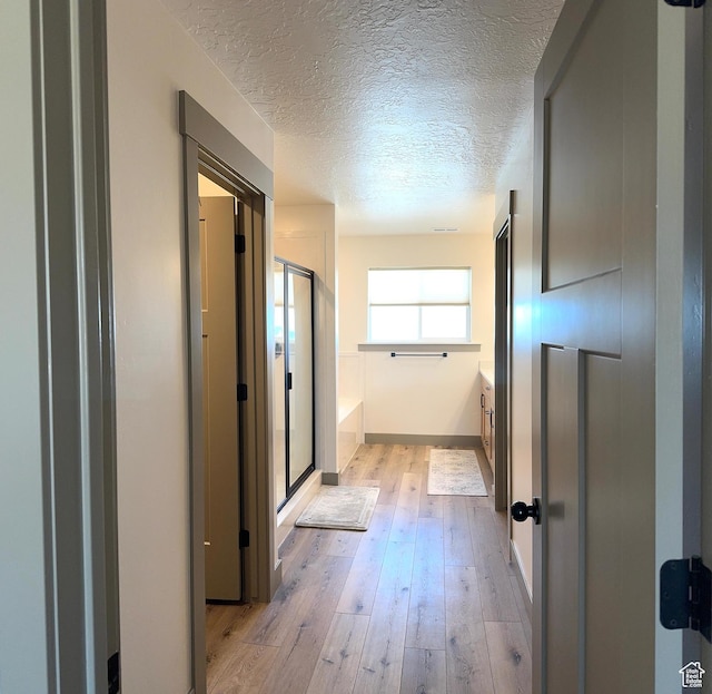 386 S Amber Field Dr Unit 508, Grantsville, UT 84029 - hallway with baseboards, light wood-style floors, and a textured ceiling