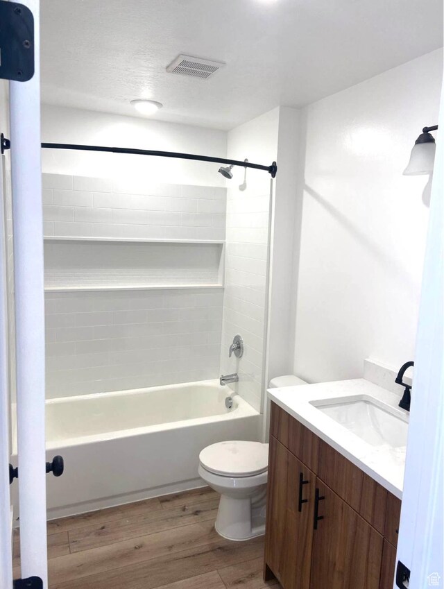 386 S Amber Field Dr Unit 508, Grantsville, UT 84029 - bathroom with vanity, toilet, shower / washtub combination, visible vents, and wood finished floors