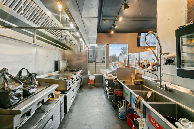 kitchen with concrete floors and white cabinets