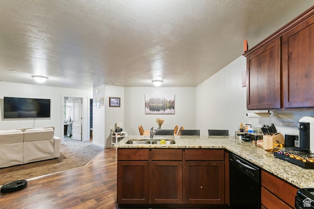 kitchen featuring a peninsula, dark wood-type flooring, a sink, open floor plan, and black appliances
