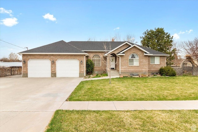 single story home featuring an attached garage, brick siding, fence, and concrete driveway